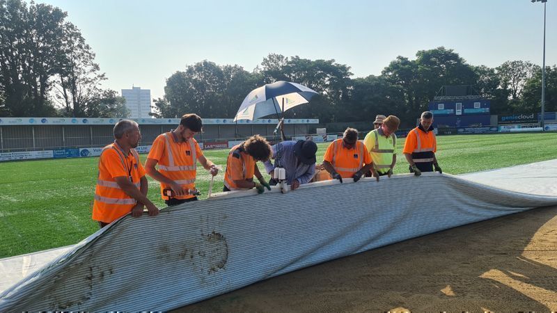Men stitching the hybridgrass carpet